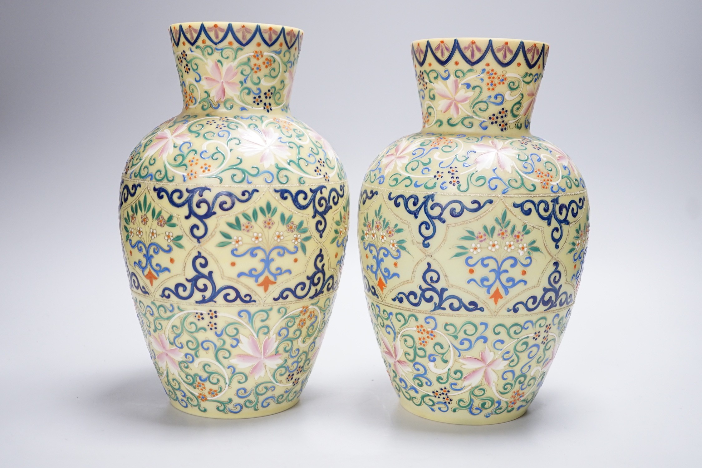A pair of French enamelled glass vases, Persian inspired, 25.5cm